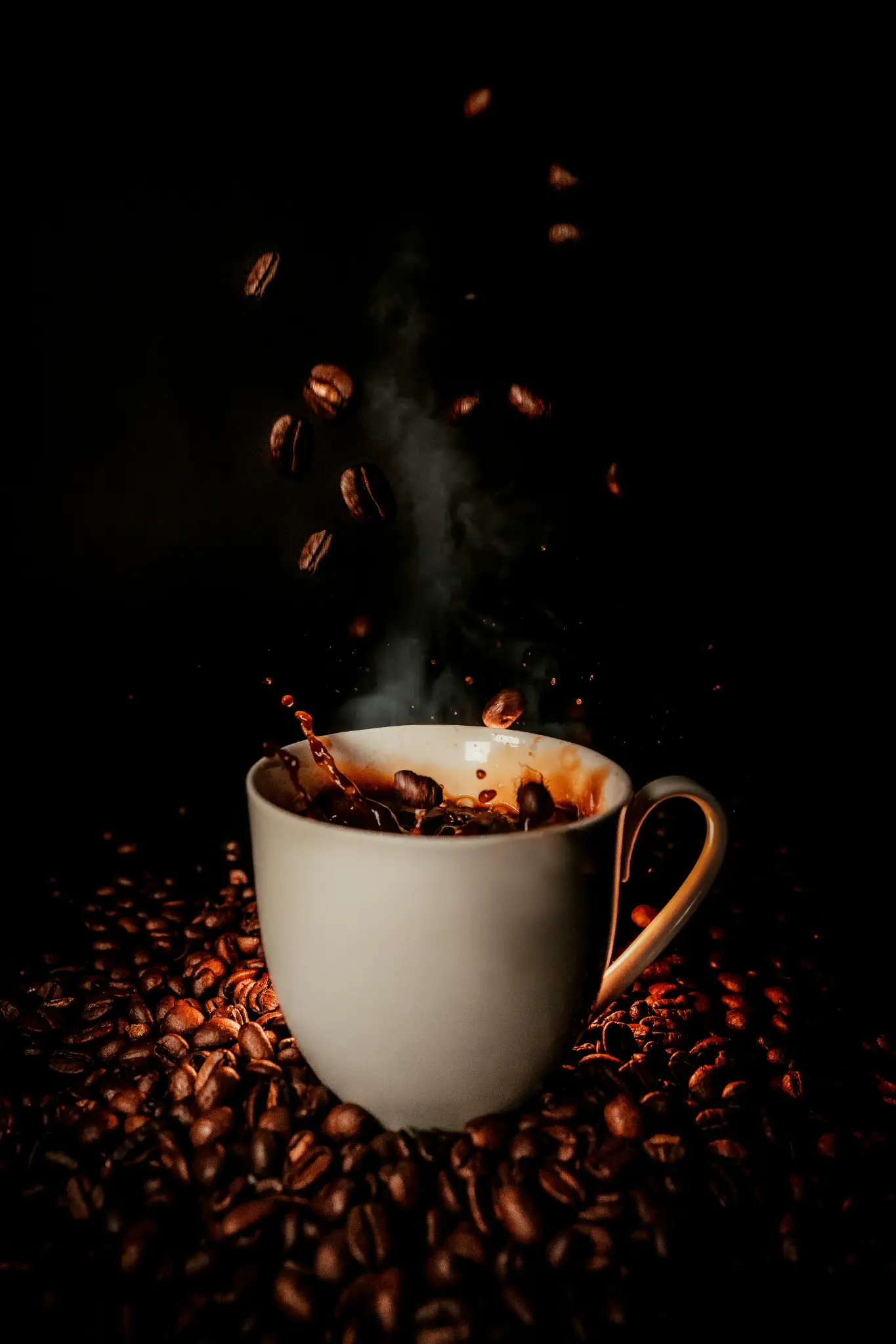 Dramatic coffee splash with beans