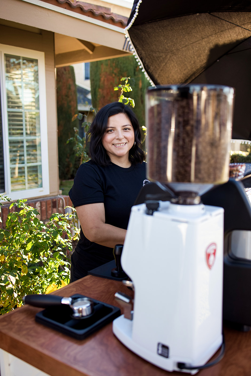 Barista working the espresso grinder at Run Wild Coffee